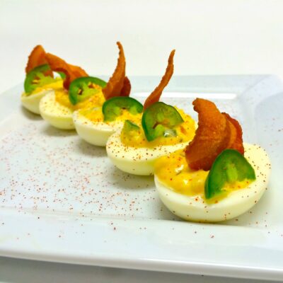 Devided eggs with smoked bacon